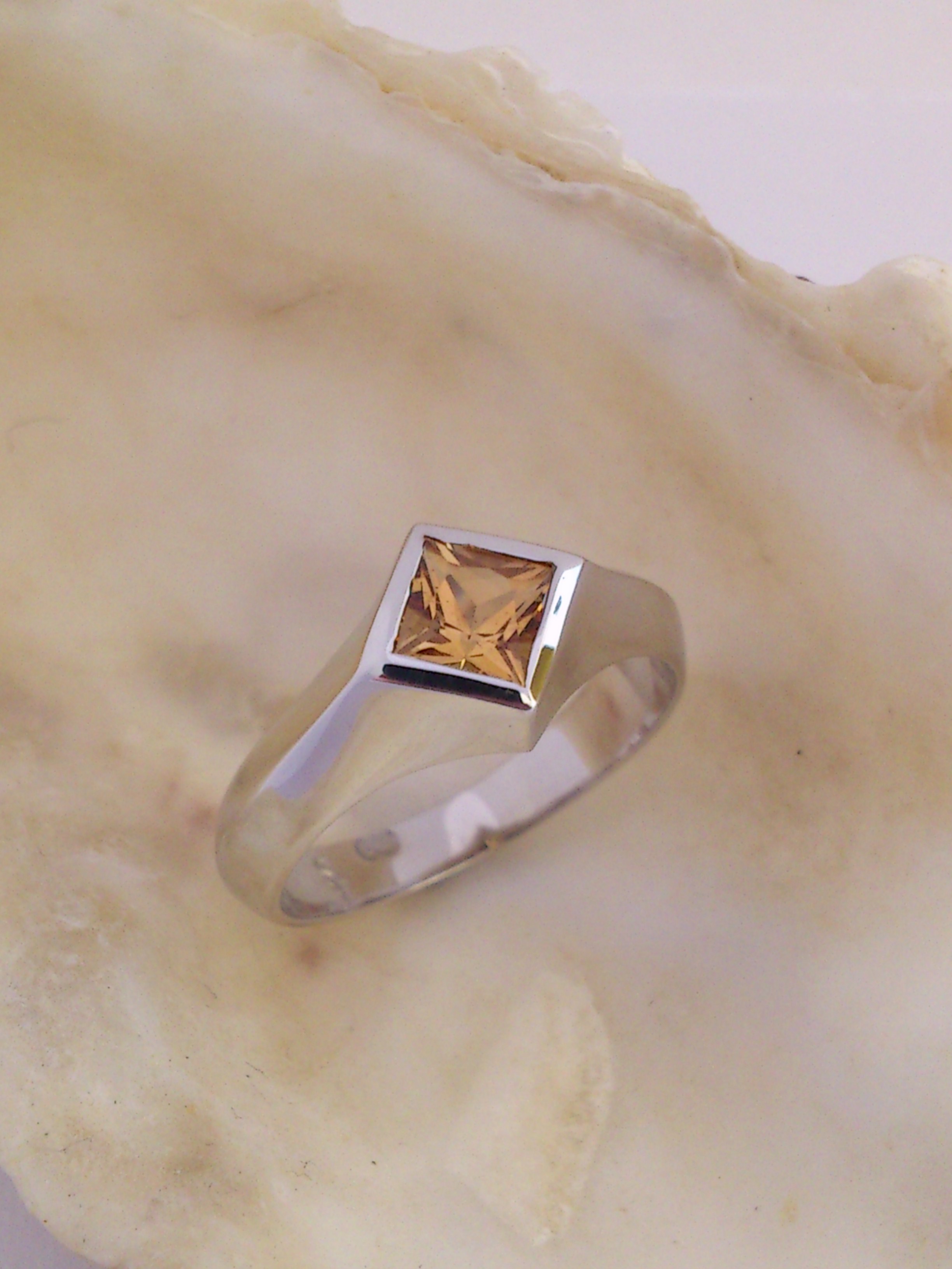 Roseberys London | A gold five stone topaz ring, the central step-cut